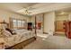 Inviting main bedroom features a stone fireplace, four poster bed, and ample natural light at 2433 Dogie Spur, Golden, CO 80403