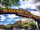Welcoming entrance sign to Golden, Colorado, with colorful buildings and vibrant street scene at 2433 Dogie Spur, Golden, CO 80403