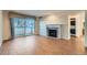 Living room with fireplace, hardwood floors, and sliding door to balcony at 444 S Kittredge St # 205, Aurora, CO 80017