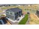 Aerial view of the home and backyard, featuring a patio area and a fenced yard at 920 William Way, Brighton, CO 80603