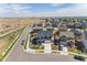 Aerial view of the home in a residential neighborhood with nearby streets and other homes at 920 William Way, Brighton, CO 80603