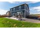 Backyard features a patio with a hot tub and furniture, perfect for relaxing or entertaining at 920 William Way, Brighton, CO 80603