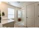 Stylish bathroom featuring a glass shower, double vanity, and contemporary design at 920 William Way, Brighton, CO 80603