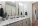 Modern bathroom featuring double sinks with white countertops and modern fixtures at 920 William Way, Brighton, CO 80603