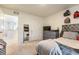 This comfortable bedroom features a dresser with a TV and a mirror hanging on the wall at 920 William Way, Brighton, CO 80603