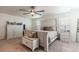 Bright bedroom with a white bed frame, ceiling fan, and a coordinated furniture set at 920 William Way, Brighton, CO 80603