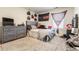 Bright bedroom featuring a gray dresser, decorated walls, and comfortable furnishings at 920 William Way, Brighton, CO 80603