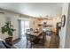 Bright dining area connected to the kitchen, featuring a glass-top table and easy access to the outdoor space at 920 William Way, Brighton, CO 80603