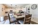Inviting dining area with a large glass table, comfortable seating, and modern fixtures at 920 William Way, Brighton, CO 80603