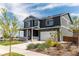 Attractive home exterior features a covered porch and meticulously landscaped front yard at 920 William Way, Brighton, CO 80603