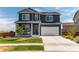 Charming two-story home with a well-maintained lawn and attached two-car garage at 920 William Way, Brighton, CO 80603