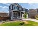 Charming two-story home featuring a welcoming front porch and attached two-car garage at 920 William Way, Brighton, CO 80603