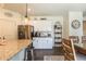 Modern kitchen and dining area with stainless steel appliances, granite countertops, and ample cabinet space at 920 William Way, Brighton, CO 80603