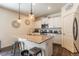 Charming kitchen features granite counters, stainless appliances, and pendant lighting at 920 William Way, Brighton, CO 80603