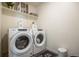 Convenient laundry room with modern appliances, decorative shelves, and stylish decor at 920 William Way, Brighton, CO 80603