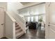 Spacious living area featuring hardwood floors, staircase, and an inviting open floorplan at 920 William Way, Brighton, CO 80603