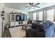 Stylish living room boasts plush seating, a large entertainment center, and an abundance of natural light at 920 William Way, Brighton, CO 80603