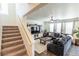 Spacious living room with a cozy couch, large TV, and lots of natural light at 920 William Way, Brighton, CO 80603