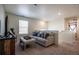 Cozy upstairs living room with plush seating, neutral tones, and natural light at 920 William Way, Brighton, CO 80603