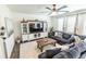 Comfortable living room boasts a ceiling fan, mounted TV and ample seating at 920 William Way, Brighton, CO 80603