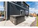 Backyard with a concrete patio featuring a hot tub, furniture, and a gas barbeque at 920 William Way, Brighton, CO 80603