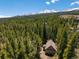 Aerial view shows the house is nestled in a lush forest, providing privacy and natural beauty at 91 Slalom Dr, Breckenridge, CO 80424
