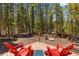 Inviting backyard deck features red Adirondack chairs and a small side table, perfect for relaxing outdoors at 91 Slalom Dr, Breckenridge, CO 80424