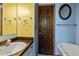 Cozy bathroom with blue and yellow walls, vanity, oval mirror and bathtub at 91 Slalom Dr, Breckenridge, CO 80424