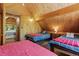 Bedroom features three beds, paneled walls and high ceilings at 91 Slalom Dr, Breckenridge, CO 80424