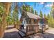 Charming home with a large deck, mature trees, and blue doors at 91 Slalom Dr, Breckenridge, CO 80424