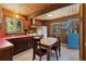 Charming kitchen features wood ceiling, cabinets, appliances, and table at 91 Slalom Dr, Breckenridge, CO 80424