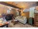 Inviting living room with a brick fireplace, wood paneling, and comfortable sofas, creating a warm atmosphere at 91 Slalom Dr, Breckenridge, CO 80424