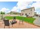Landscaped backyard with a patio, fire pit area, and seating, ideal for relaxation and outdoor activities at 7218 Animas Ave, Frederick, CO 80530