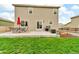 Spacious backyard with a patio, dining set, grill, and garden bed, providing ample space for outdoor enjoyment at 7218 Animas Ave, Frederick, CO 80530