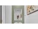 Half bathroom with decorative mirror, stylish light fixture, and a modern vessel sink at 7218 Animas Ave, Frederick, CO 80530