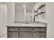 Bathroom vanity featuring granite countertops, modern wood shelves, and a large mirror at 7218 Animas Ave, Frederick, CO 80530