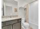 Bright bathroom featuring granite countertops, vanity, and a shower/tub combo with neutral tones at 7218 Animas Ave, Frederick, CO 80530