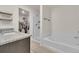 Elegant bathroom with a granite countertop vanity, soaking tub, walk-in shower, and access to walk-in closet at 7218 Animas Ave, Frederick, CO 80530