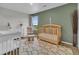 Charming Bedroom featuring neutral tones, a cozy chair, and a stylish crib at 7218 Animas Ave, Frederick, CO 80530