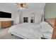 Well-lit bedroom with plush carpet, a ceiling fan, and view to the en suite bathroom with vanity and mirror at 7218 Animas Ave, Frederick, CO 80530