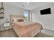 Cozy bedroom with a large window, sliding closet doors, and a neutral color scheme with soft textures at 7218 Animas Ave, Frederick, CO 80530