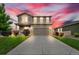 Charming two-story home with landscaped front yard, long driveway, and attached two-car garage at sunset at 7218 Animas Ave, Frederick, CO 80530
