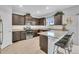 Modern kitchen with stainless steel appliances, granite countertops, and seating at the counter at 7218 Animas Ave, Frederick, CO 80530