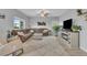 Cozy living room with a large sectional sofa, fireplace, and light-colored carpet at 7218 Animas Ave, Frederick, CO 80530