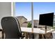 Close up view of home office with large window, modern desk and chair with a beautiful exterior view at 7218 Animas Ave, Frederick, CO 80530
