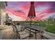 Outdoor patio featuring a dining set with an umbrella and grill, perfect for entertaining and enjoying the outdoors at 7218 Animas Ave, Frederick, CO 80530