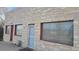 Building facade featuring stone exterior and red accents at 3818 S Lowell Blvd, Sheridan, CO 80236