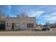 Stone building with red framed windows and doors at 3818 S Lowell Blvd, Sheridan, CO 80236