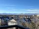 Residential area with snow-covered rooftops and mountain views beyond at 10184 Park Meadows Dr # 1406, Lone Tree, CO 80124