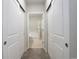 Hallway view to bathroom with tile floor, double closets and lots of lights at 10184 Park Meadows Dr # 1406, Lone Tree, CO 80124